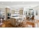 Bright kitchen with a large island, stainless steel appliances, breakfast table and an abundance of natural light at 5582 Twilight Way, Parker, CO 80134