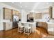 Spacious kitchen with stainless steel appliances, island, wooden floors, and light-colored cabinets at 5582 Twilight Way, Parker, CO 80134