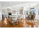 Bright, open kitchen featuring an island with seating, modern appliances, and a dining nook with picturesque windows at 5582 Twilight Way, Parker, CO 80134