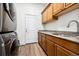 Laundry room featuring front load washer and dryer, cabinets, granite countertops, and wood floors at 5582 Twilight Way, Parker, CO 80134