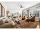 Open concept living room and kitchen with hardwood floors, large windows, and a neutral color palette at 5582 Twilight Way, Parker, CO 80134
