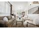 Open concept living space with hardwood floors and neutral color palette, seamlessly flowing into the dining area at 5582 Twilight Way, Parker, CO 80134