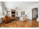 Comfortable living room featuring a stone fireplace, built-in shelves, hardwood floors, and neutral-toned furniture at 5582 Twilight Way, Parker, CO 80134