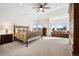 Spacious main bedroom featuring vaulted ceilings, large windows, sitting area, and neutral color palette at 5582 Twilight Way, Parker, CO 80134