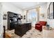 Stylish home office with custom built-ins, a large desk, and a comfortable seating area at 5582 Twilight Way, Parker, CO 80134