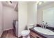Bathroom features a toilet, sink with dark countertop, wood floors, and a washer and dryer at 19357 E 40Th Ave, Denver, CO 80249
