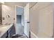 Bathroom with a marble countertop vanity, and tiled shower, showcasing a blend of style and functionality at 19357 E 40Th Ave, Denver, CO 80249