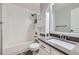 This bathroom features bright white subway tile in the shower, a white vanity and gray tile flooring at 19357 E 40Th Ave, Denver, CO 80249