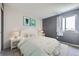 Bright bedroom offers neutral walls, a patterned bedspread, and a window with outdoor views at 19357 E 40Th Ave, Denver, CO 80249