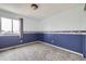 Bedroom featuring plush carpeting, blue accents, baseboard trim and a bright window at 19357 E 40Th Ave, Denver, CO 80249