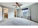 This bedroom features a closet, an en suite bathroom, a window, and plush carpeting at 19357 E 40Th Ave, Denver, CO 80249