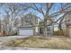 Two-story green home with a two car garage and mature landscaping in front at 19357 E 40Th Ave, Denver, CO 80249
