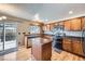 Well-equipped kitchen with wooden cabinets, granite countertops, and stainless steel appliances at 19357 E 40Th Ave, Denver, CO 80249