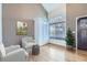 Bright living room with a tall window, hardwood floors, and comfortable seating at 19357 E 40Th Ave, Denver, CO 80249