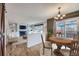 Open-concept living room with a fireplace, built-in shelves, and sliding glass doors to the patio at 19357 E 40Th Ave, Denver, CO 80249