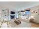 Cozy living room featuring a fireplace, built-in shelves, comfortable seating and lots of natural light at 19357 E 40Th Ave, Denver, CO 80249