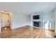 Cozy living room with a fireplace, TV, built-in storage and hardwood floors at 19357 E 40Th Ave, Denver, CO 80249