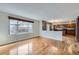 View from the living room into the kitchen and dining room with hardwood floors at 19357 E 40Th Ave, Denver, CO 80249