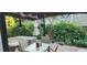 Cozy backyard patio area featuring a hot tub, and lush greenery, ideal for relaxation and privacy at 19357 E 40Th Ave, Denver, CO 80249