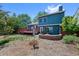 Backyard with brick fire pit, deck and well-maintained lawn surrounded by mature trees at 7226 S Eagles Nest Cir, Littleton, CO 80127