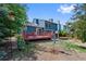 Backyard features spacious deck and brick fire pit with mature trees at 7226 S Eagles Nest Cir, Littleton, CO 80127