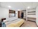 Finished basement bedroom features an egress window, closet and extra shelves at 7226 S Eagles Nest Cir, Littleton, CO 80127