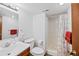 Updated bathroom boasts a clean shower and wood vanity with a modern sink and fixtures at 7226 S Eagles Nest Cir, Littleton, CO 80127