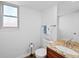 Cozy powder room with granite countertop, dark wood cabinetry, and decorative fixtures at 7226 S Eagles Nest Cir, Littleton, CO 80127