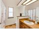 Bathroom with a wooden vanity and countertop, a large mirror, and a shower with curtain at 7226 S Eagles Nest Cir, Littleton, CO 80127
