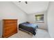 Bedroom features neutral carpet, a window with natural light, and a wood dresser at 7226 S Eagles Nest Cir, Littleton, CO 80127