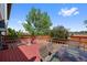 A backyard wooden deck provides a serene outdoor space, complemented by a table and chairs and lush greenery at 7226 S Eagles Nest Cir, Littleton, CO 80127