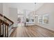 Dining area with wood floors, staircase, and view of the outside from the windows at 7226 S Eagles Nest Cir, Littleton, CO 80127