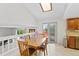 Eat in kitchen featuring a skylight, light tile floors, and a sliding door to an outdoor deck at 7226 S Eagles Nest Cir, Littleton, CO 80127