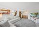 Bright open-concept living room with wet bar, stairs to upper level and exterior door at 7226 S Eagles Nest Cir, Littleton, CO 80127
