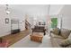 Open-concept living room with hardwood floors, staircase, and a view into the dining area at 7226 S Eagles Nest Cir, Littleton, CO 80127