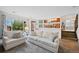 Open-concept living room with access to a patio, stairs to the upper floor, and partial view of kitchen at 7226 S Eagles Nest Cir, Littleton, CO 80127