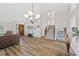 Spacious living room showcasing hardwood floors, staircase, and a view to the front door at 7226 S Eagles Nest Cir, Littleton, CO 80127