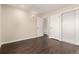 Cozy bedroom featuring closet with sliding doors and wood laminate flooring at 2301 E Fremont Ave # W08, Centennial, CO 80122