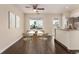 Bright dining area features a ceiling fan, dark wood floors, and an adjacent kitchen with granite countertops at 2301 E Fremont Ave # W08, Centennial, CO 80122