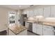 The kitchen has granite countertops, stainless steel appliances, and pristine white cabinetry at 2301 E Fremont Ave # W08, Centennial, CO 80122