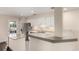 Bright kitchen with white cabinets, stainless steel refrigerator, and granite countertops at 2301 E Fremont Ave # W08, Centennial, CO 80122