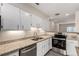 Gourmet kitchen features granite countertops, stainless appliances, and sleek white cabinetry at 2301 E Fremont Ave # W08, Centennial, CO 80122
