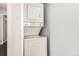 White stacked washer and dryer are conveniently located indoors at 2301 E Fremont Ave # W08, Centennial, CO 80122