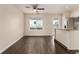 Bright living room with ceiling fan, wood floors, large window and breakfast bar to kitchen at 2301 E Fremont Ave # W08, Centennial, CO 80122