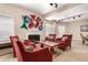 Inviting lobby with red chairs centered around a fireplace and unique wall decor at 2301 E Fremont Ave # W08, Centennial, CO 80122