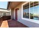 Exterior view of the brick patio, red door, and large windows at 2301 E Fremont Ave # W08, Centennial, CO 80122