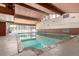 Indoor pool featuring natural wood beam ceiling and bright airy space at 2301 E Fremont Ave # W08, Centennial, CO 80122