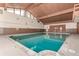 Indoor pool featuring natural wood beam ceiling and bright airy space at 2301 E Fremont Ave # W08, Centennial, CO 80122
