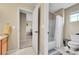 Neutral bathroom with a shower and bathtub combination, toilet, and neutral cabinets at 5778 S Duquesne Ct, Aurora, CO 80016