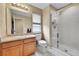 Well-lit bathroom featuring a glass-enclosed shower, neutral color scheme, and a functional vanity with storage at 5778 S Duquesne Ct, Aurora, CO 80016